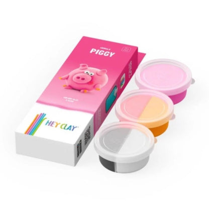 HEY CLAY boetseerklei varken set met roze verpakking en drie open potjes klei in verschillende kleuren