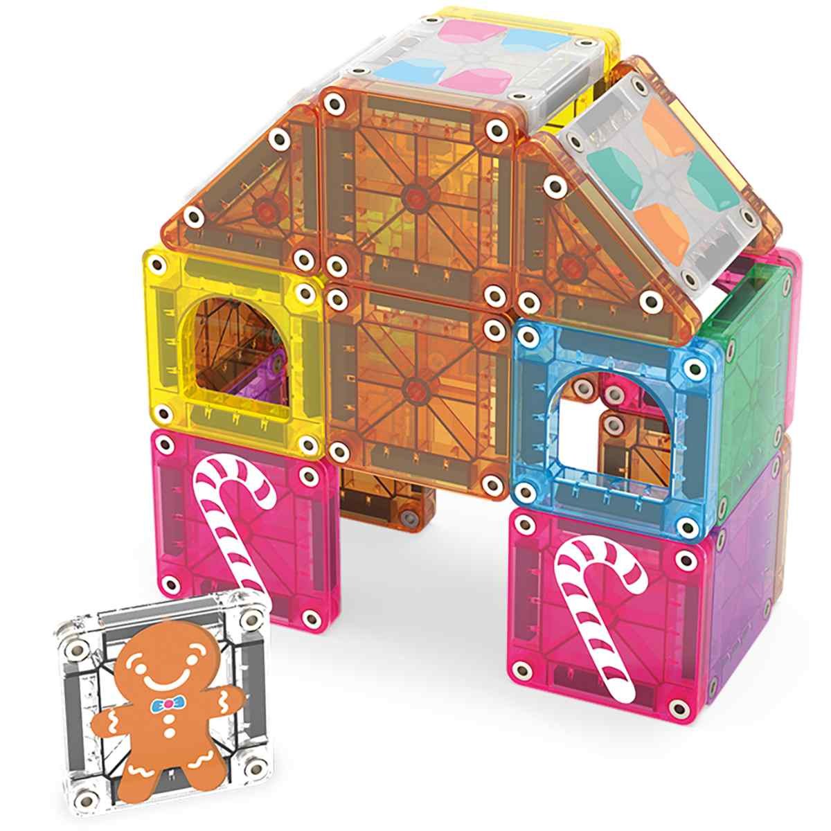Magna-Tiles magnetische bouwset in peperkoekhuis-thema, huisvormige opstelling met gekleurde transparante tegels en gingerbread man.