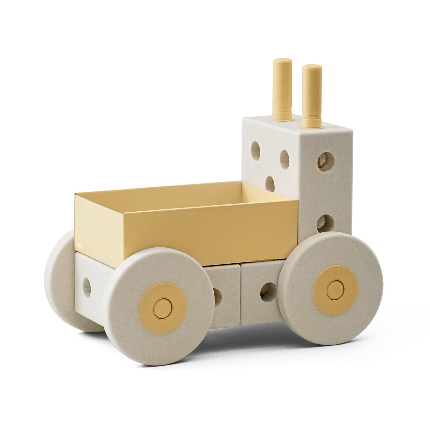 MODU 3-in-1 Babywalker in sand grey en honey yellow, aanzicht van voren met gele laadkak, wielen met gouden accenten en witte kubusvormige blok achter