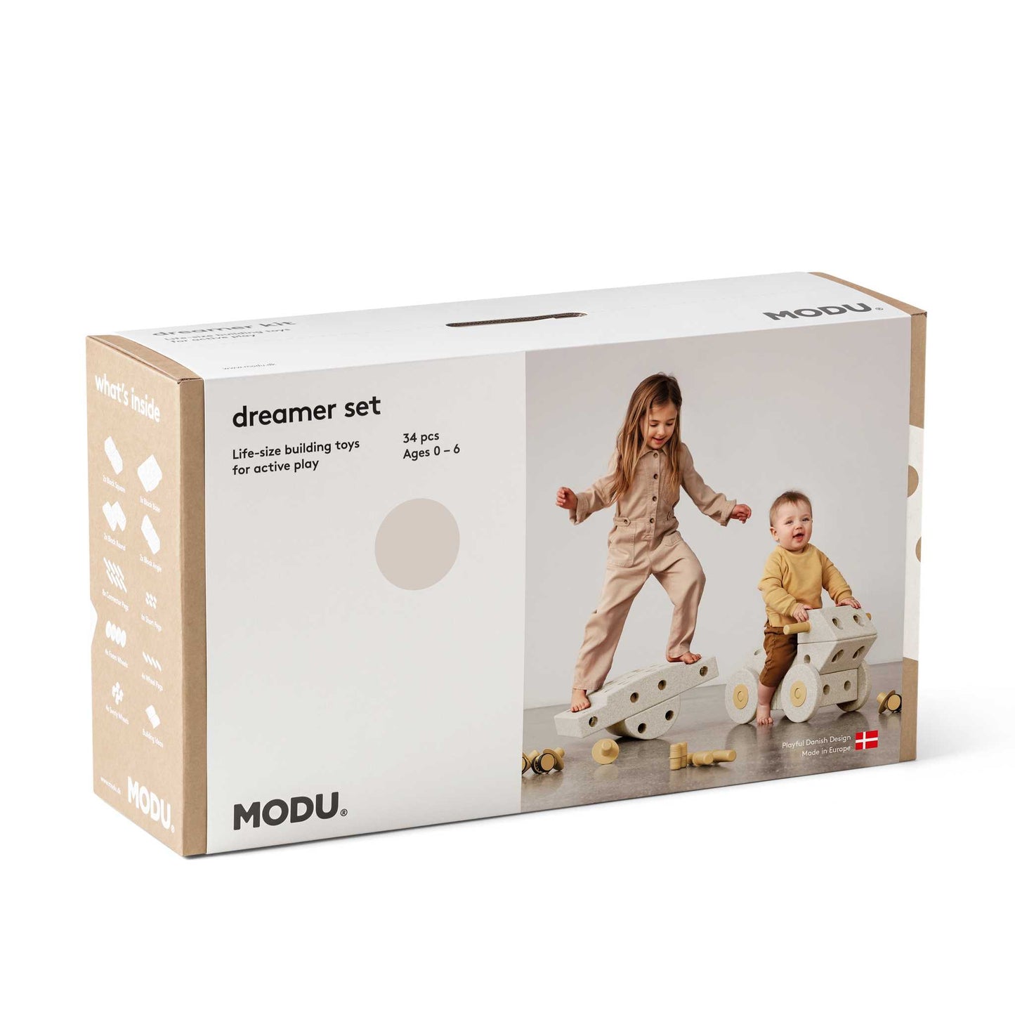 MODU Dreamer Set verpakking met twee kinderen spelend op grote bouwblokken, zandgrijs en honingkleurig schuimblokken zichtbaar.