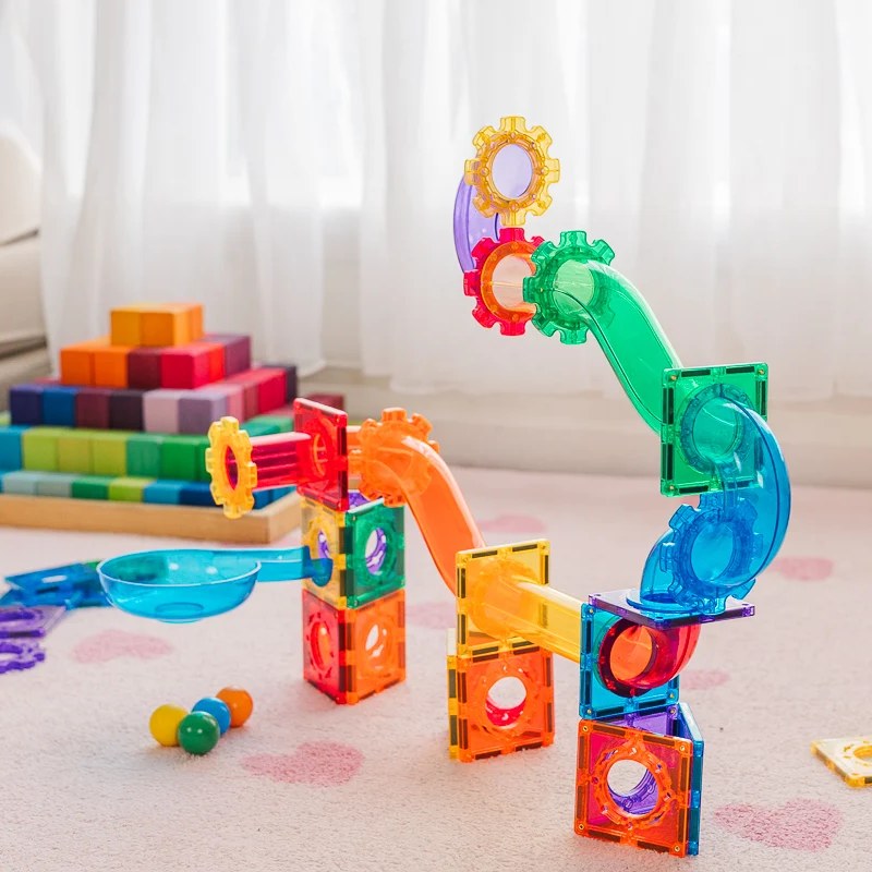 Learn and Grow Toys magnetische tegels ballrun: kleurrijke spiraal- en glijbaanconstuctie met knikkers op speelmat.