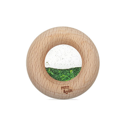 Petit Boum sensorische donut groen met houten ring, vooraanzicht met zichtbare glitter beweging
