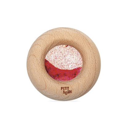 Petit Boum sensorische calm donut in rood met houten ring en glitter, bovenaanzicht op witte achtergrond