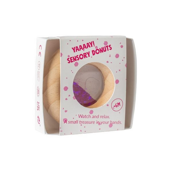 Petit Boum sensorische donut in roze verpakking, donutvormig speelgoed in houten natuurlijke tint met paarse vloeistof binnenin, zichtbaar door raam o